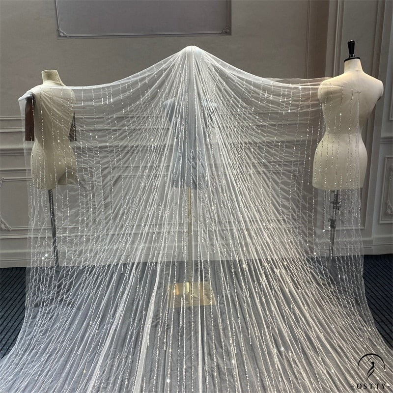 https://www.ostty.com/cdn/shop/products/wedding-veil-with-comb-cathedral-bridal-sequins-beaded-long-sparkle-luxury-veils-real-photo-ostty-188.jpg?v=1641775901